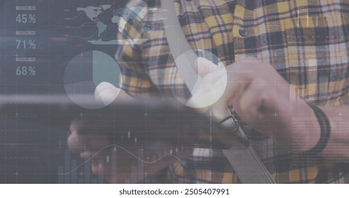 Image of financial data processing over caucasian man with tablet on the go. Global finance, business, connections, computing and data processing concept digitally generated image.