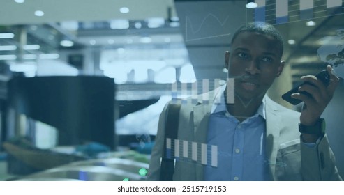 Image of financial data processing over afrcian american businessman with smartphone. Global finance, business, connections, computing and data processing concept digitally generated image.