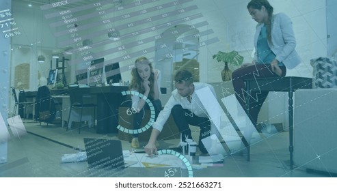 Image of financial data processing over diverse business people in office. Global finance, business, connections, computing and data processing concept digitally generated image.