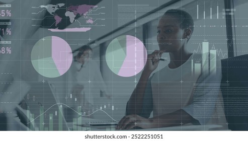 Image of financial data processing over african american businesswoman in office. Global finance, business, connections, computing and data processing concept digitally generated image.