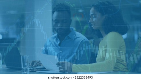 Image of financial data processing over diverse colleagues discussing work in office. Business, finances, office, communication, teamwork and digital interface concept digitally generated image.