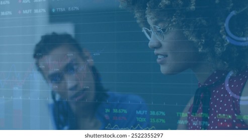 Image of financial data processing over diverse colleagues discussing work in office. Business, finances, office, communication, teamwork and digital interface concept digitally generated image.
