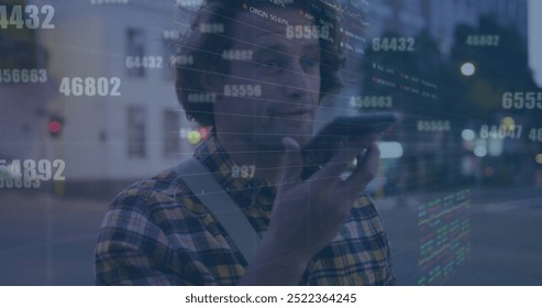 Image of financial data processing over caucasian man using smartphone in city. Global finance, business, connections, computing and data processing concept digitally generated image.