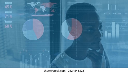 Image of financial data processing over african american businesswoman in office. Global finance, business, connections, computing and data processing concept digitally generated image.