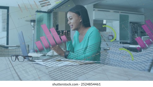 Image of financial data processing over biracial woman using smartphone. Global finance, business, connections, computing and data processing concept digitally generated image.