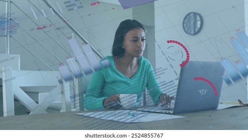 Image of financial data processing over biracial woman using laptop. Global finance, business, connections, computing and data processing concept digitally generated image.