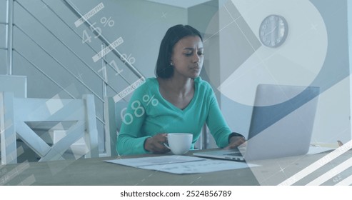 Image of financial data processing over biracial woman using laptop. Global finance, business, connections, computing and data processing concept digitally generated image.