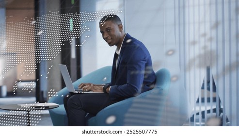 Image of financial data processing over african american businessman using laptop. Global finance, business, connections, computing and data processing concept digitally generated image.