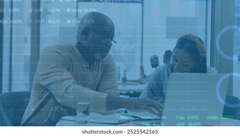 Image of financial data processing over diverse business people using laptop. Global finance, business, connections, computing and data processing concept digitally generated image.
