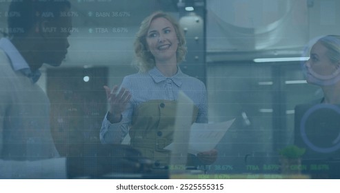 Image of financial data processing over diverse business people in office. Global finance, business, connections, computing and data processing concept digitally generated image.
