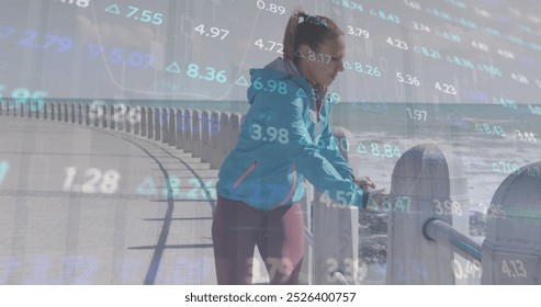 Image of financial data processing over caucasian woman stretching. Global sports, business, finances, computing and data processing concept digitally generated image.