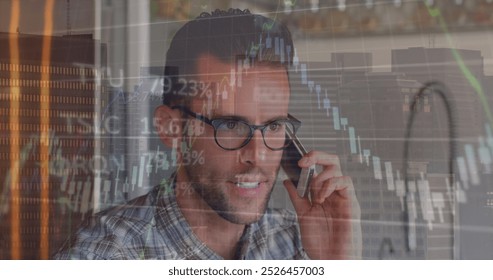 Image of financial data processing over biracial man talking on smartphone against tall building. Global economy and business technology concept