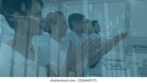 Image of financial data processing over diverse business people in office. Global business, finance, computing and data processing concept digitally generated image.