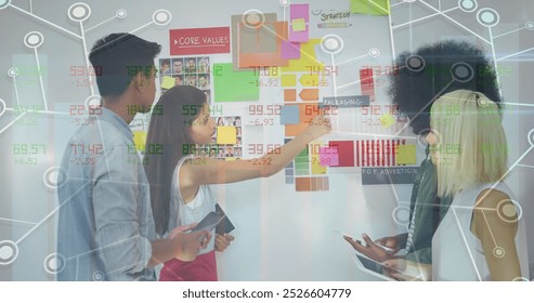 Image of financial data processing over diverse business people working at office. Global business, finances and digital interface concept digitally generated image.