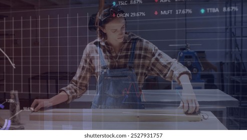 Image of financial data processing over woman working in workshop. Global computing, finance, business and data processing concept digitally generated image.