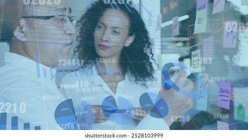 Image of financial data processing over diverse business people in office. Global business, finances, computing and data processing concept digitally generated image.