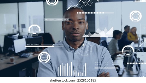 Image of financial data processing over african american businessman in office. Global finance, business, connections, computing and data processing concept digitally generated image.