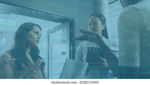 Image of financial data processing over diverse colleagues having meeting in office. Business, finances, teamwork and digital interface concept digitally generated image.