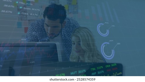 Image of financial data processing over diverse colleagues working in office. Global business, finances, computing and digital interface concept digitally generated image.