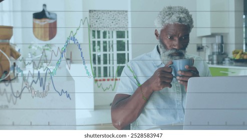 Image of financial data processing over senior african american man using laptop. Global finance, business, connections, computing and data processing concept digitally generated image.