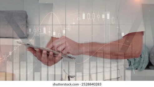 Image of financial data processing over caucasian businessman using tablet. Global business, connections, computing and data processing over concept digitally generated image.