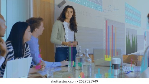 Image of financial data processing over diverse business people in office. Global business, finance, connections, computing and data processing concept digitally generated image.