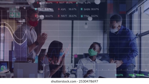 Image of financial data processing over diverse business people wearing face masks. Global business, finances and digital interface during covid 19 pandemic concept digitally generated image. - Powered by Shutterstock