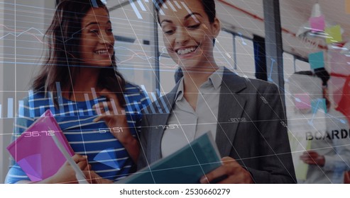 Image of financial data processing over two diverse businesswomen. global business, finances, digital interface and connections concept digitally generated image.