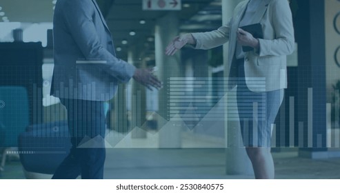 Image of financial data processing over two diverse business people. Global business and data processing concept digitally generated image.