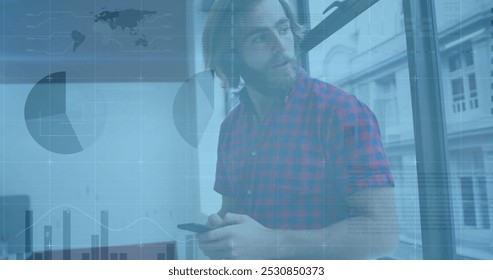Image of financial data processing over caucasian businessman using smartphone. Global finance, business, connections, computing and data processing concept digitally generated image.