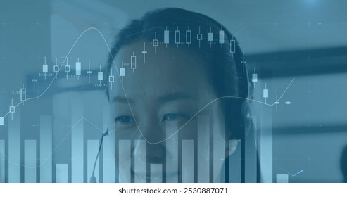 Image of financial data processing over asian businesswoman using phone headset in office. Global business and digital interface concept digitally generated image. - Powered by Shutterstock