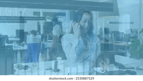 Image of financial data processing over diverse business people in office. Global business and digital interface concept digitally generated image.