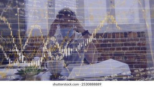 Image of financial data processing over businessman wearing face mask. global business, finances, connections and digital interface during covid 19 pandemic concept digitally generated image. - Powered by Shutterstock