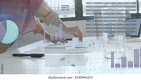 Image of financial data processing over caucasian businesswoman working in office. Global business, finance, computing and data processing concept digitally generated image.