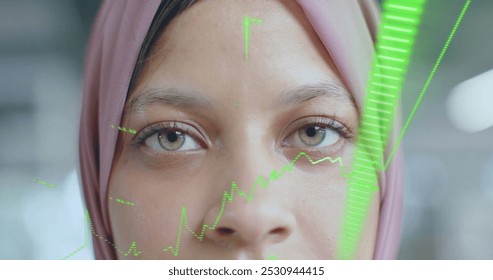 Image of financial data processing over biracial businesswoman in hijab in office. Global business, finance, computing and data processing concept digitally generated image. - Powered by Shutterstock