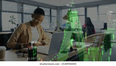 Image of financial data processing over diverse businesswomen in office. Global business, finance, computing and data processing concept digitally generated image.