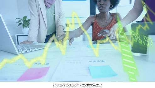 Image of financial data processing over diverse business people in office. Global business, finance, computing and data processing concept digitally generated image.