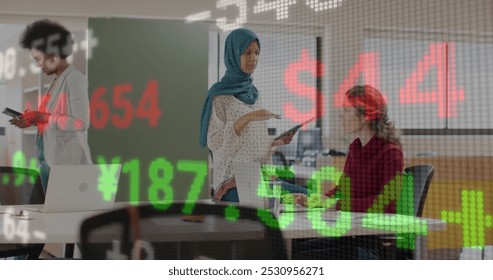 Image of financial data processing over diverse business people in office. Global business, finance, computing and data processing concept digitally generated image.