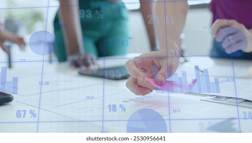 Image of financial data processing over diverse business people in office. Global business, finance, computing and data processing concept digitally generated image.