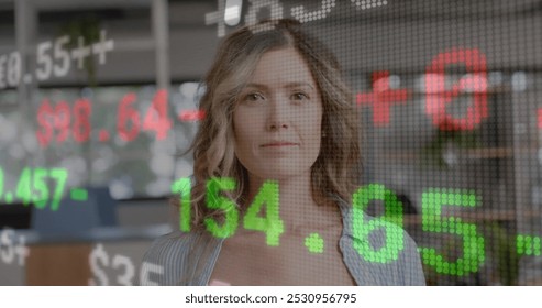 Image of financial data processing over caucasian businesswoman working in office. Global business, finance, computing and data processing concept digitally generated image.