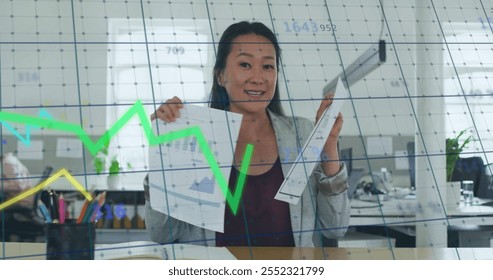 Image of financial data processing over biracial businesswoman in office. Global finance, business, connections, computing and data processing concept digitally generated image.