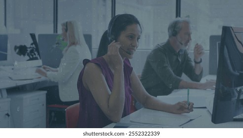 Image of financial data processing over diverse business people in office. Global finance, business, connections, computing and data processing concept digitally generated image. - Powered by Shutterstock