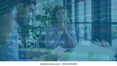 Image of financial data processing over diverse business people in office. Global finance, business, connections, computing and data processing concept digitally generated image.
