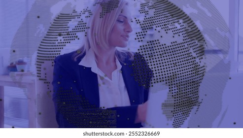 Image of financial data processing over caucasian businesswoman using laptop in office. Global finance, business, connections, computing and data processing concept digitally generated image.