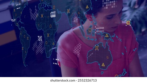 Image of financial data processing over caucasian businesswoman using laptop in office. Global finance, business, connections, computing and data processing concept digitally generated image.