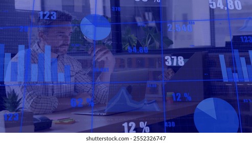 Image of financial data processing over caucasian businessman using laptop in office. Global finance, business, connections, computing and data processing concept digitally generated image.