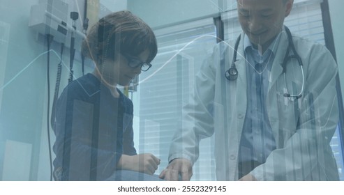 Image of financial data processing over diverse male doctor and boy patient. Global medicine, healthcare, computing and digital interface concept digitally generated image. - Powered by Shutterstock