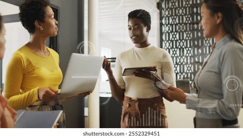 Image of financial data processing over diverse colleagues discussing work in office. Global business, finances, computing, communication and digital interface concept digitally generated image.