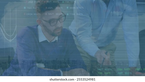 Image of financial data processing over diverse colleagues discussing work in office. Global business, finances and digital interface concept digitally generated image.