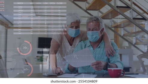 Image of financial data processing over senior caucasian couple wearing face masks. Senior lifestyle, finances, communication and digital interface concept digitally generated image. - Powered by Shutterstock